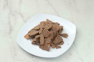 banana chips with cocoa powder served on a white plate photo