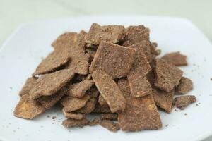 banana chips with cocoa powder served on a white plate photo