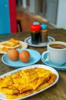 Traditional breakfast set and coffee, boiled eggs and toast, popular in Singapore photo
