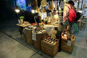 BANGKOK - June 15, 2018 local crafted watch and souvenir stall at night market in Pathum Wan district, ideal for artisan handicraft items. From cloths and watches to dry fruit photo