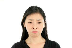 Facial Expression mid aged asian woman office attire white background sad unhappy photo