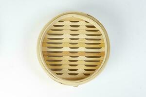 Wooden bamboo dim sum steamer on white background photo