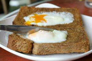 Poached fried egg on brown whole meal brad toast photo