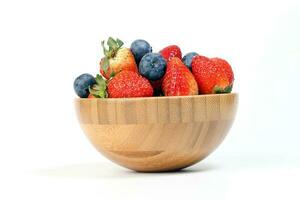 Strawberry blueberry in wooden bowl on white background photo