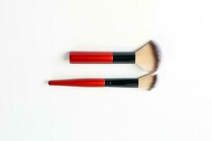 Red black makeup brush beauty accessories on white background photo