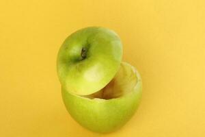 Healthy Green Cut Apple floating top slice juice drink idea concept on yellow background photo