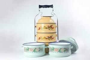 Vintage retro tin tiffin food two three tier carrier on white background photo