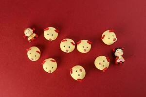 Chinese New Year rat mouse shaped cookie boy girl doll on red background photo