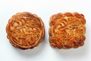 Chinese baked decorated mooncake mid autumn festival round square moon cake filling gift wish offering on white background photo