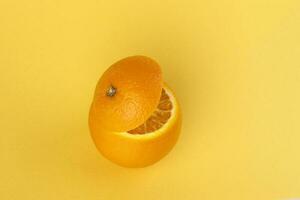 Healthy Orange Cut floating top slice juice drink idea concept on yellow background photo