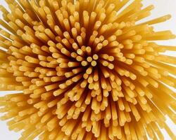 dry raw spaghetti white background blooming flower sunray glow pattern concept macro closeup photo