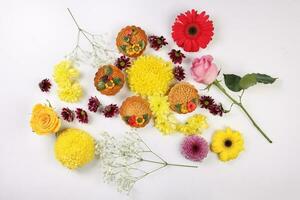 Colorful flower decorated moon cake Chinese mid autumn festival daisy chrysanthemum mum rose baby breath flower red yellow pink purple violet on white background photo