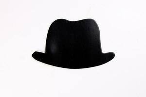 Black hat shape paper die cut selfie portrait party fun paper prop sticker stick on white background photo