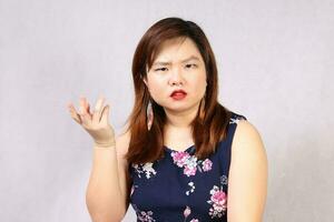 Young attractive southeast Asian woman posing facial expression angry question photo