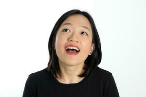 Young attractive south east asian woman pose face expression emotion on white background wonder happy look up photo