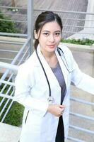 South East Asian young Malay Chinese man woman medical doctor stethoscope apron group stand pose confident photo