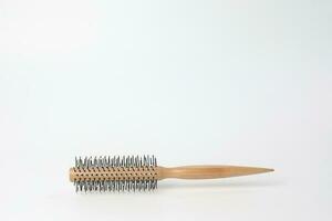 Round hair brush comb on white background photo