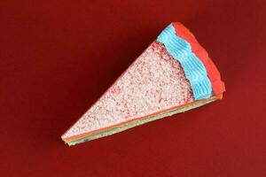 Rainbow crepe layer cake top view on red background photo