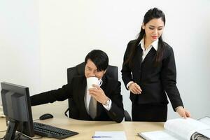 Young Asian man woman wearing business office suit chair table computer white background photo