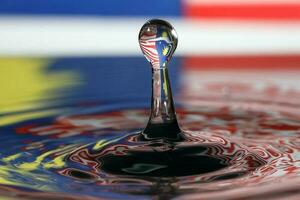 Water droplet drop splash collision dripping pillar Malaysia Flag reflection refraction independence country patriot photo