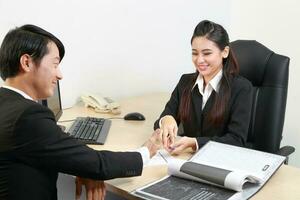 Young Asian man woman wearing business office suit chair table computer white background photo