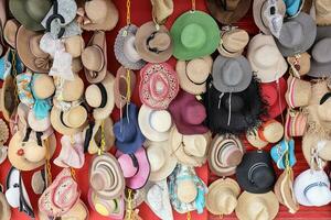 Hat shop display colorful variety hats hanging on the wall photo