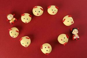 Chinese New Year rat mouse shaped cookie boy girl doll on red background photo