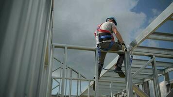 Shock Absorbing Lanyard and Safety Harness Equipment. Work at Height Safety. Caucasian Contractor on a Steel Building Frame. video