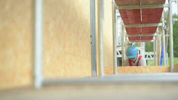 Work at Height. Construction Industry. Caucasian Contractor Worker in His 30s on a Scaffolding. video