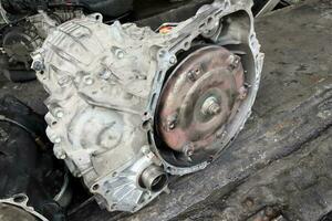 Old dirty used broken Auto transmission gearbox on workshop floor for damaged repair photo