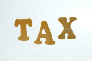 Tax text alphabet writing type on white background photo