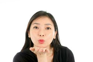 Facial Expression Young Asian woman office attire white background blow kiss palm of hand photo