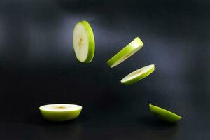 Levitated green apple slices photo