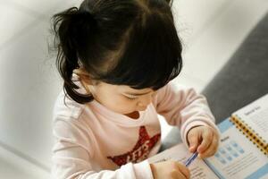 Child daughter on sofa reading writing study teaching photo