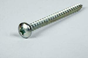 Metal screw plug on white background photo