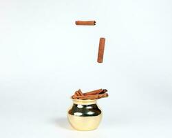 Cinnamon in shiny metal pot photo