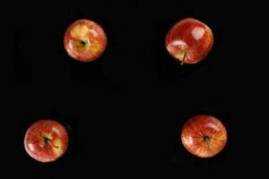 Red apple on black background photo