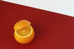 Healthy Orange Cut floating top slice juice drink idea concept on red white background photo