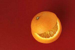 Healthy Orange Cut floating top slice juice drink idea concept on red background photo