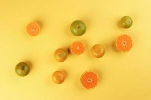 mall yellow green mandarin orange whole slice on yellow background copy space for text photo