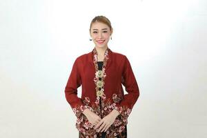 Asian woman traditional red maroon kebaya sharong on white background happy smile photo