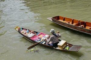 BANGKOK, THAILAND May 03, 2019 Damnoen Saduak Floating Market is a floating market in Damnoen Saduak District, Ratchaburi Province, about 100 kilometers southwest of Bangkok. photo