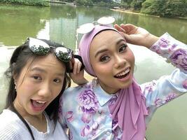 Two young Malaysian woman happy pose photo