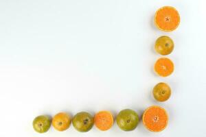 small yellow green mandarin orange whole slice on white background copy space for text frame border photo