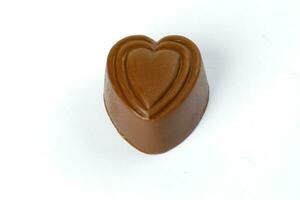 Chocolate truffle hart square cube rose flower shape on white background photo