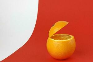 Healthy Orange Cut floating top slice juice drink idea concept on red white background photo