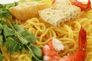 Fresh yellow egg noodle prawn tofu coriander leaf on whit background photo