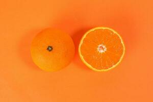 Mandarin Orange Fruit slice half on orange background photo