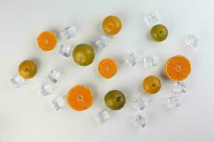small yellow green mandarin ice cube orange whole slice on white background copy space for text photo
