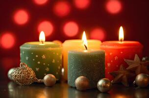 Burning candle and Christmas decoration over snow and wooden background. . photo